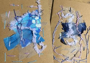 Abstract textile collage on cardboard using blue fabric, netting, and pastel yarns in a torn, layered arrangement.