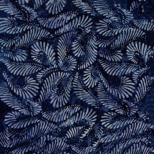 Blue batik fabric with repeating light-blue fern-like spiral patterns on a dark navy background.